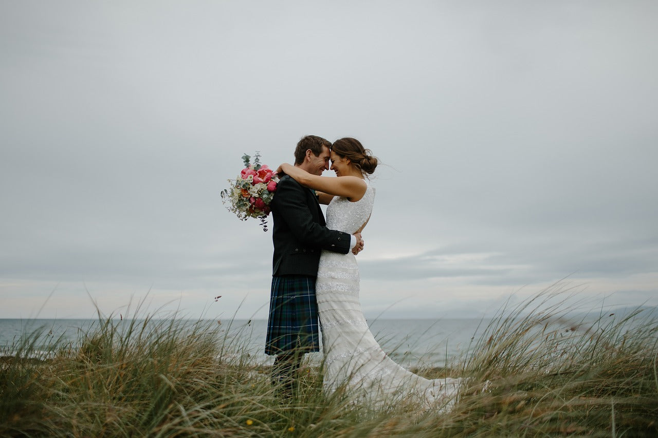 Bride and groom embracing on a beach