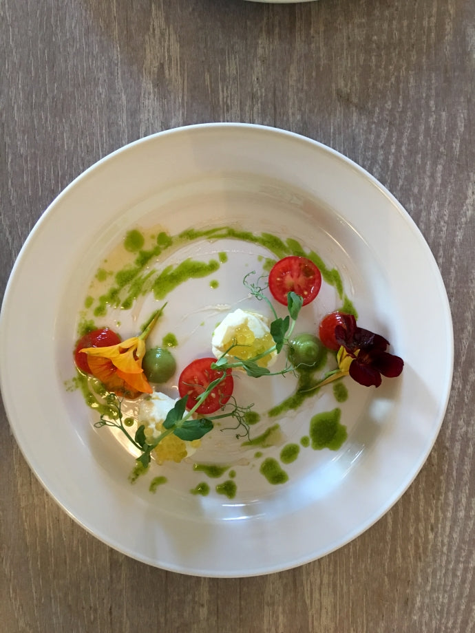 Orange soaked Macroom mozzerella on a plate seen from above