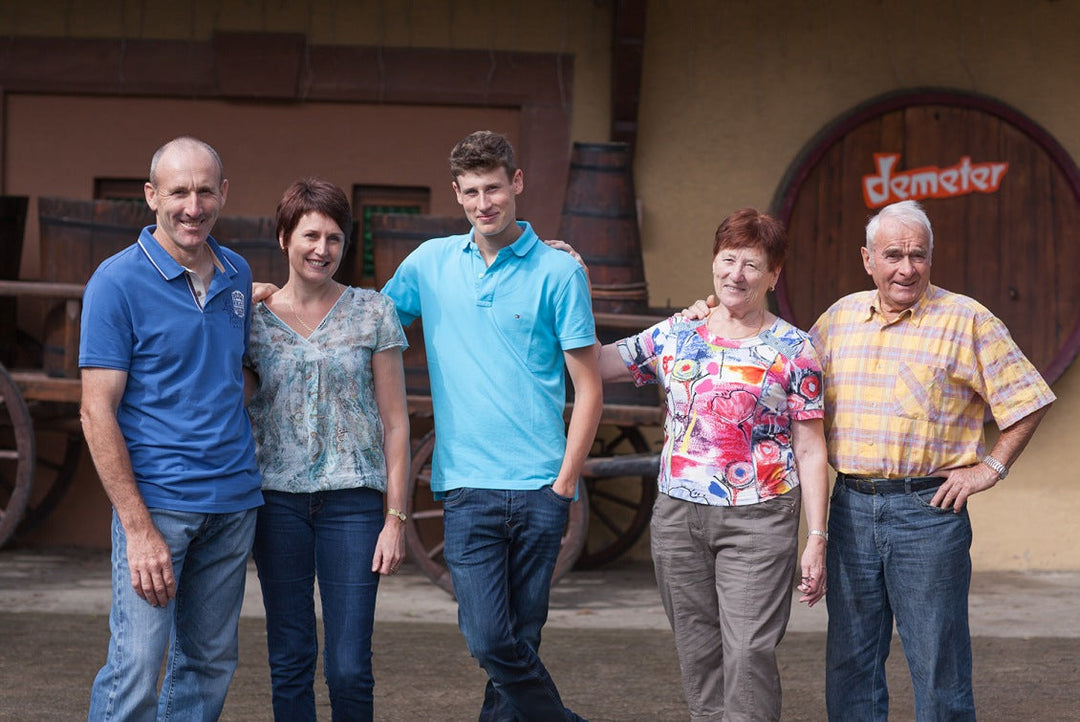 Five members of a family standing in front of their winery