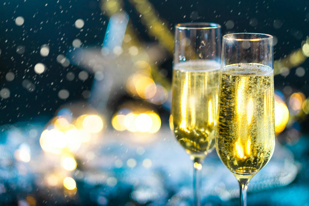 two glasses of sparkling wine or crémant against a blurred festive background