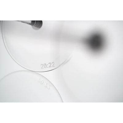 Close-up of the base of a crystal wine glass showing the 20:22 brand motif