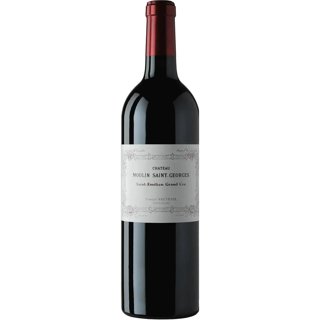 A bottle of Chateau Moulin Saint Georges Saint-Emilion Grand Cru red wine, featuring a dark glass body, a white paper label, and a dark red foil capsule at the neck, set against a solid white background.